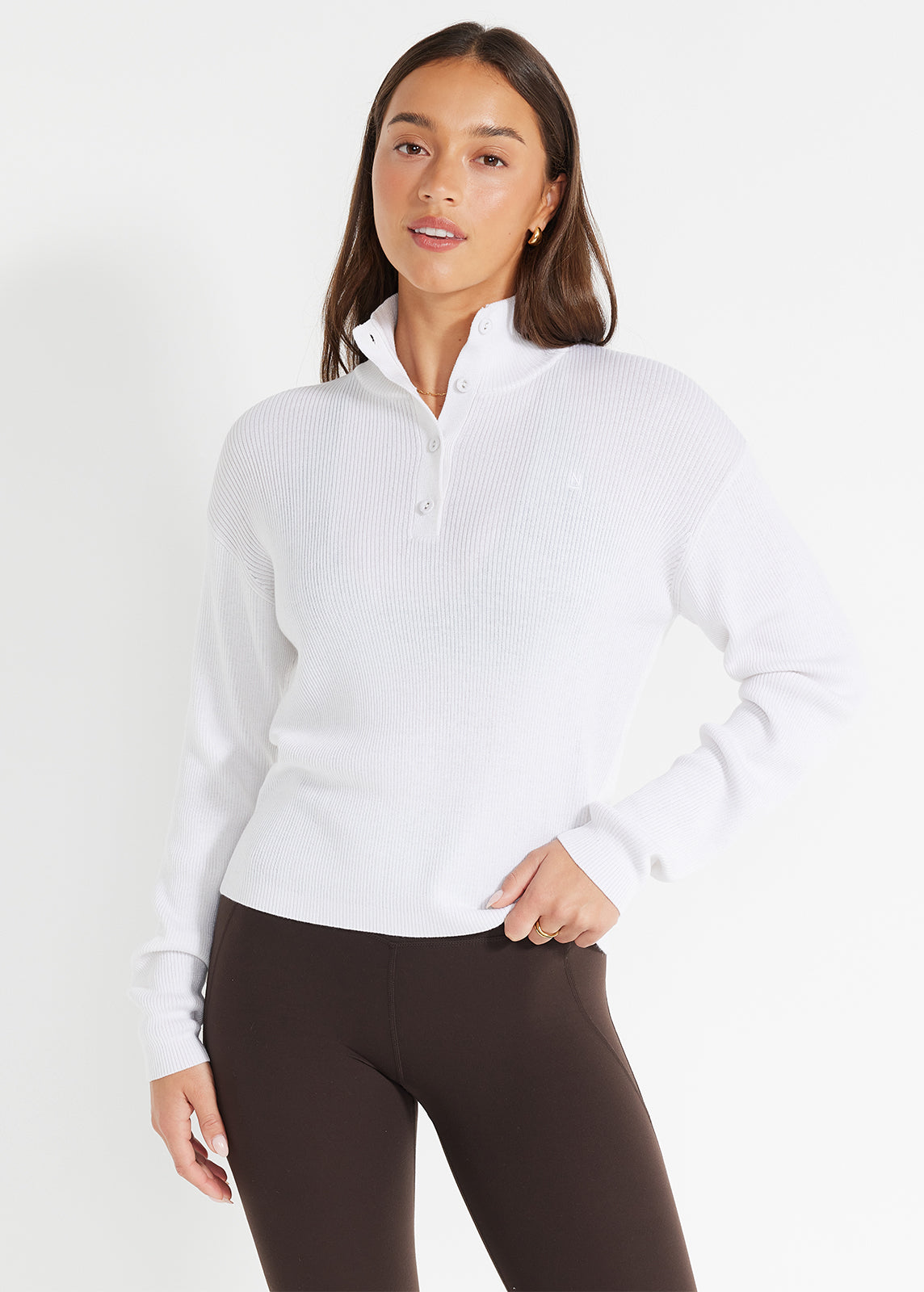 Model wearing beige knit jumper layered over leggings