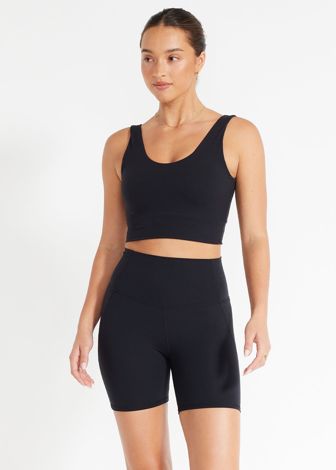 Model wearing black scoop crop and high-rise bike shorts designed for movement