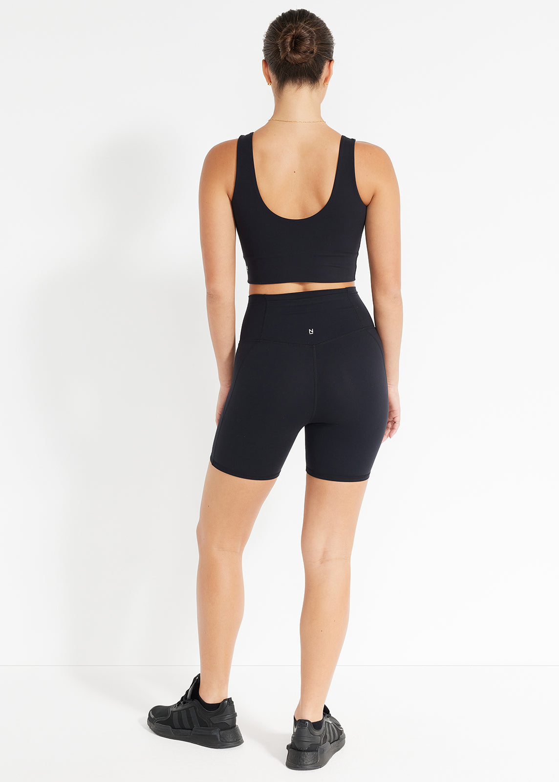 Back view of black scoop crop and bike shorts designed for comfortable movement