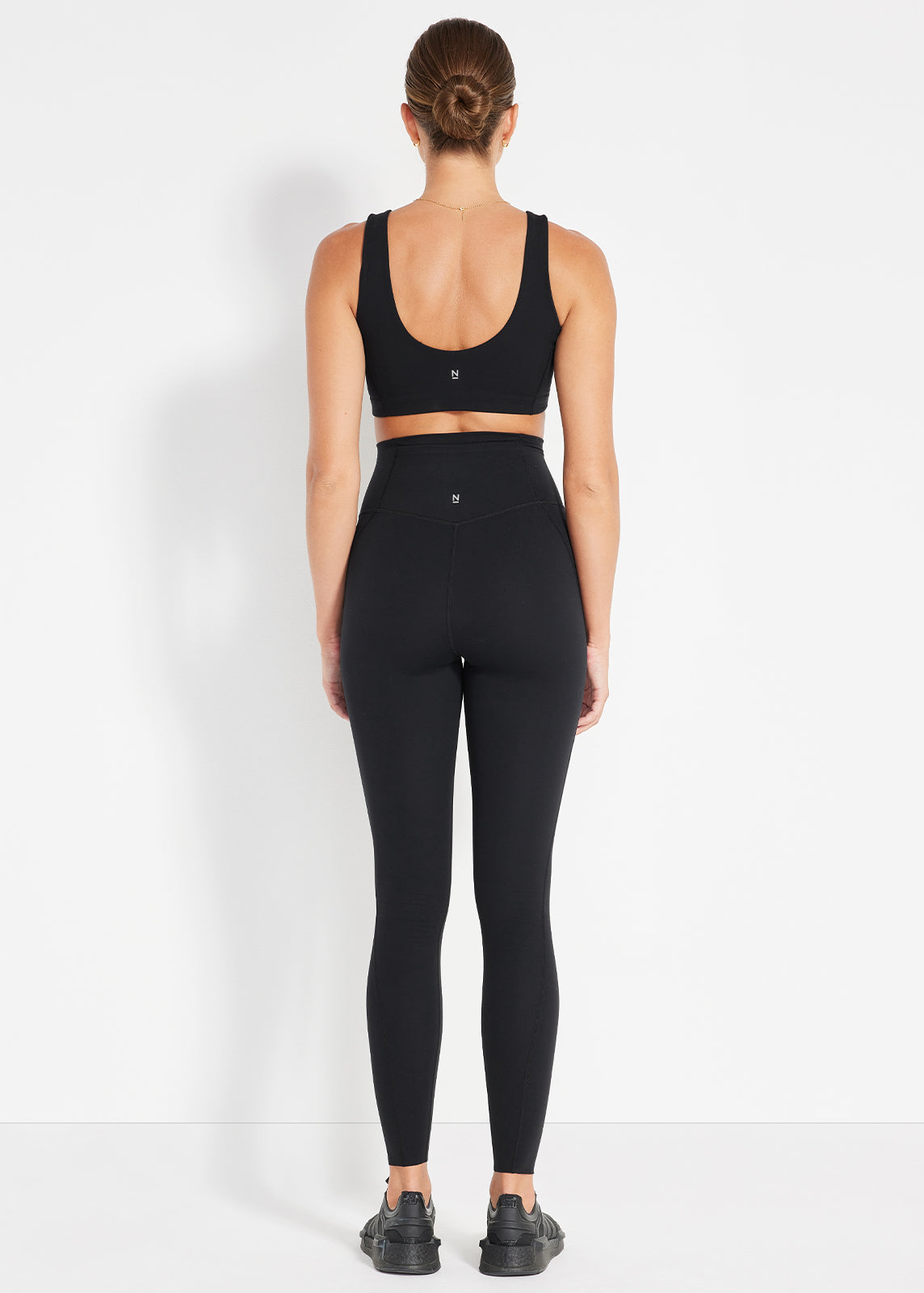 Back view of black scoop bra and bike shorts designed for a smooth, supportive fit