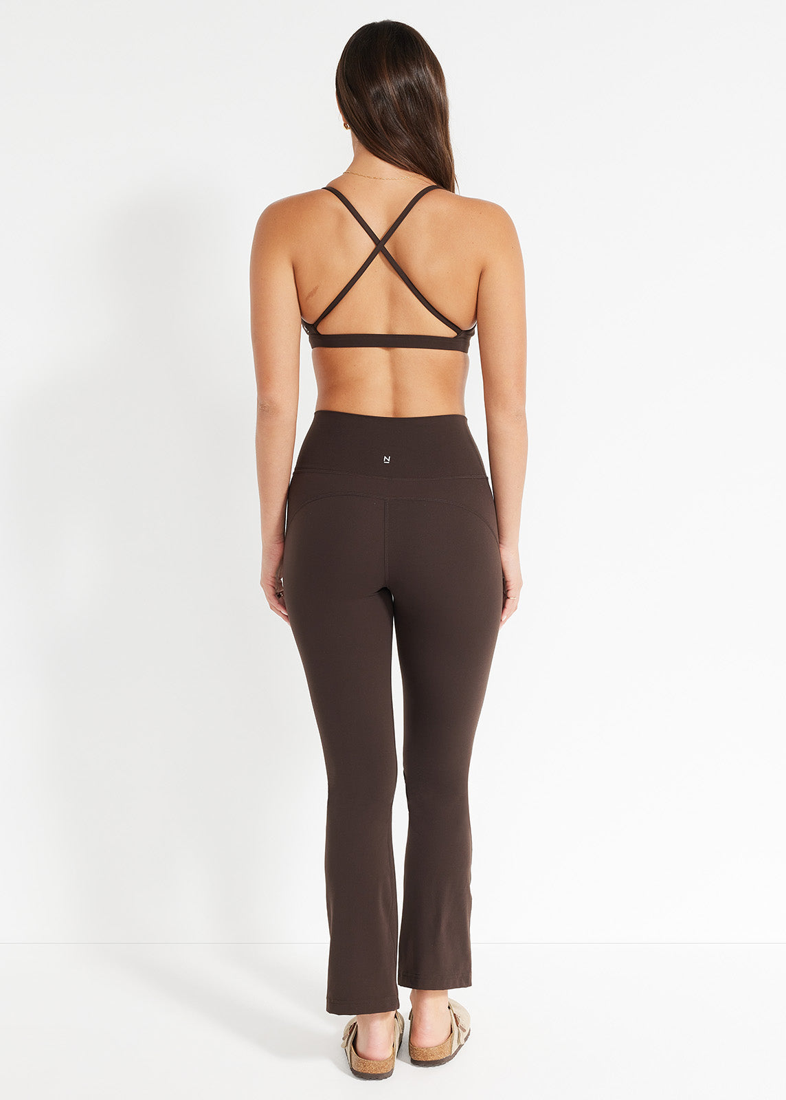 Side view of chocolate flare leggings and matching crop top