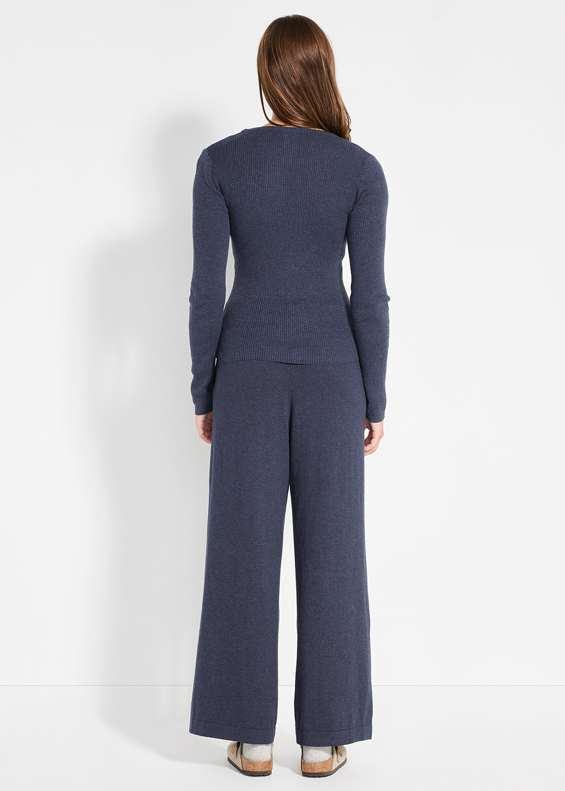 Back view of navy ribbed knit top paired with matching wide-leg lounge pants