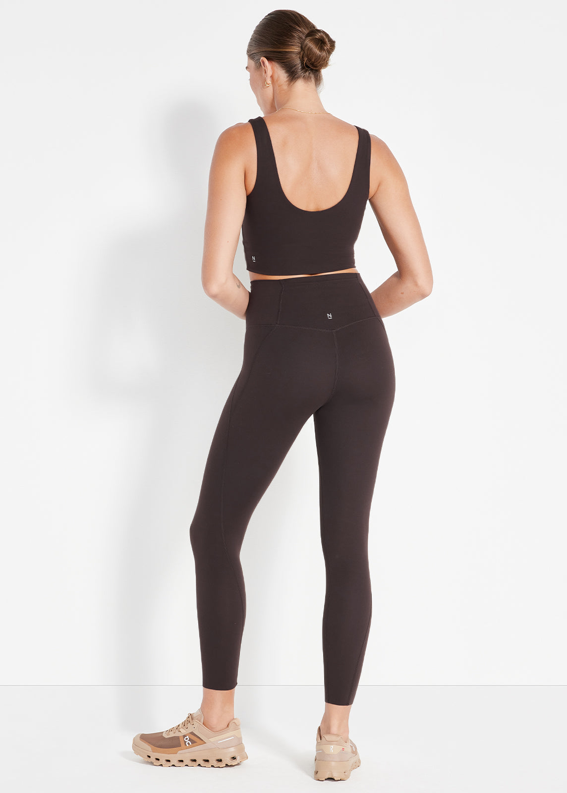 Product image of model wearing black scoop crop top and matching high-rise leggings