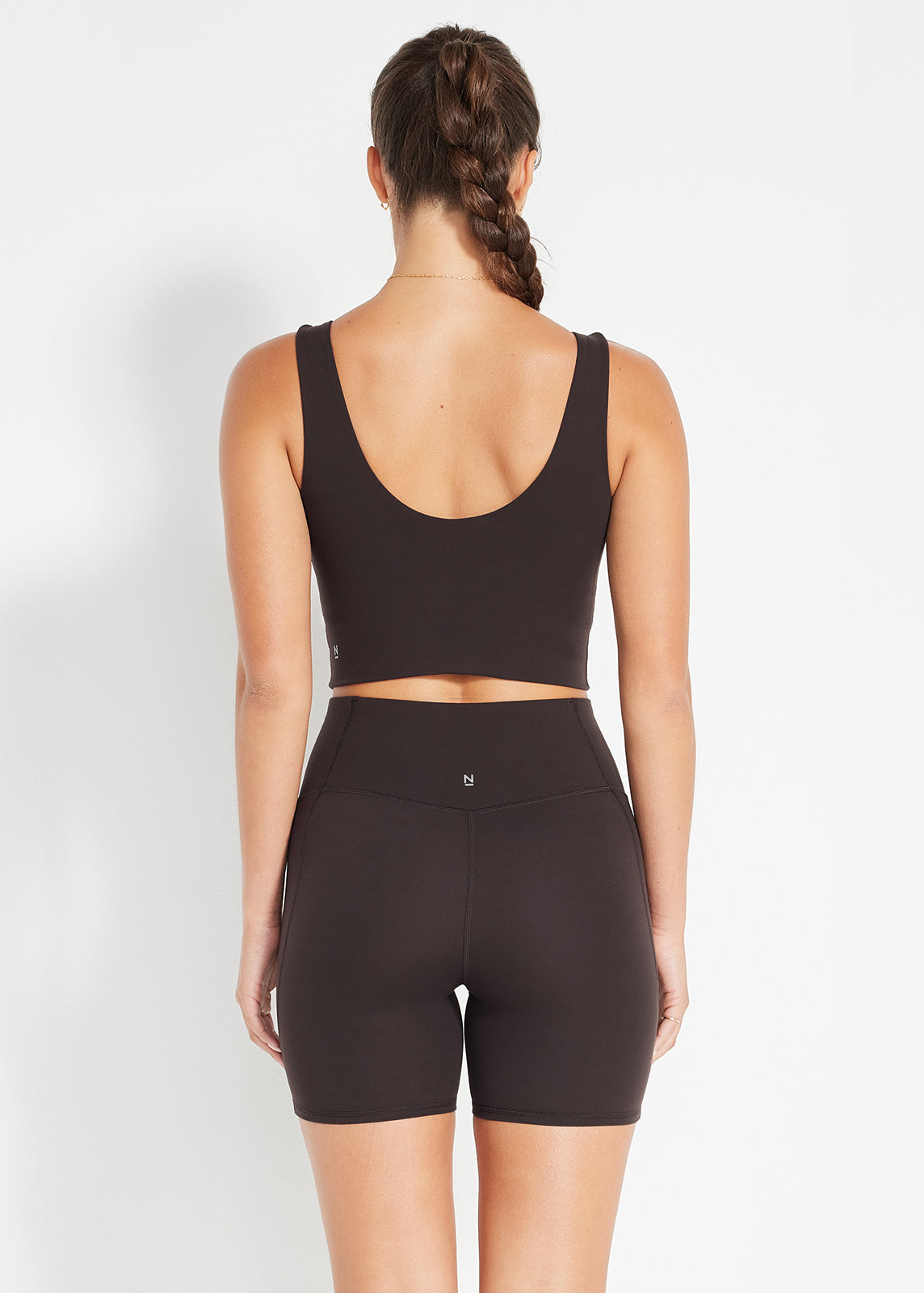Back view of espresso crop top and bike short set showing smooth, seamless fit