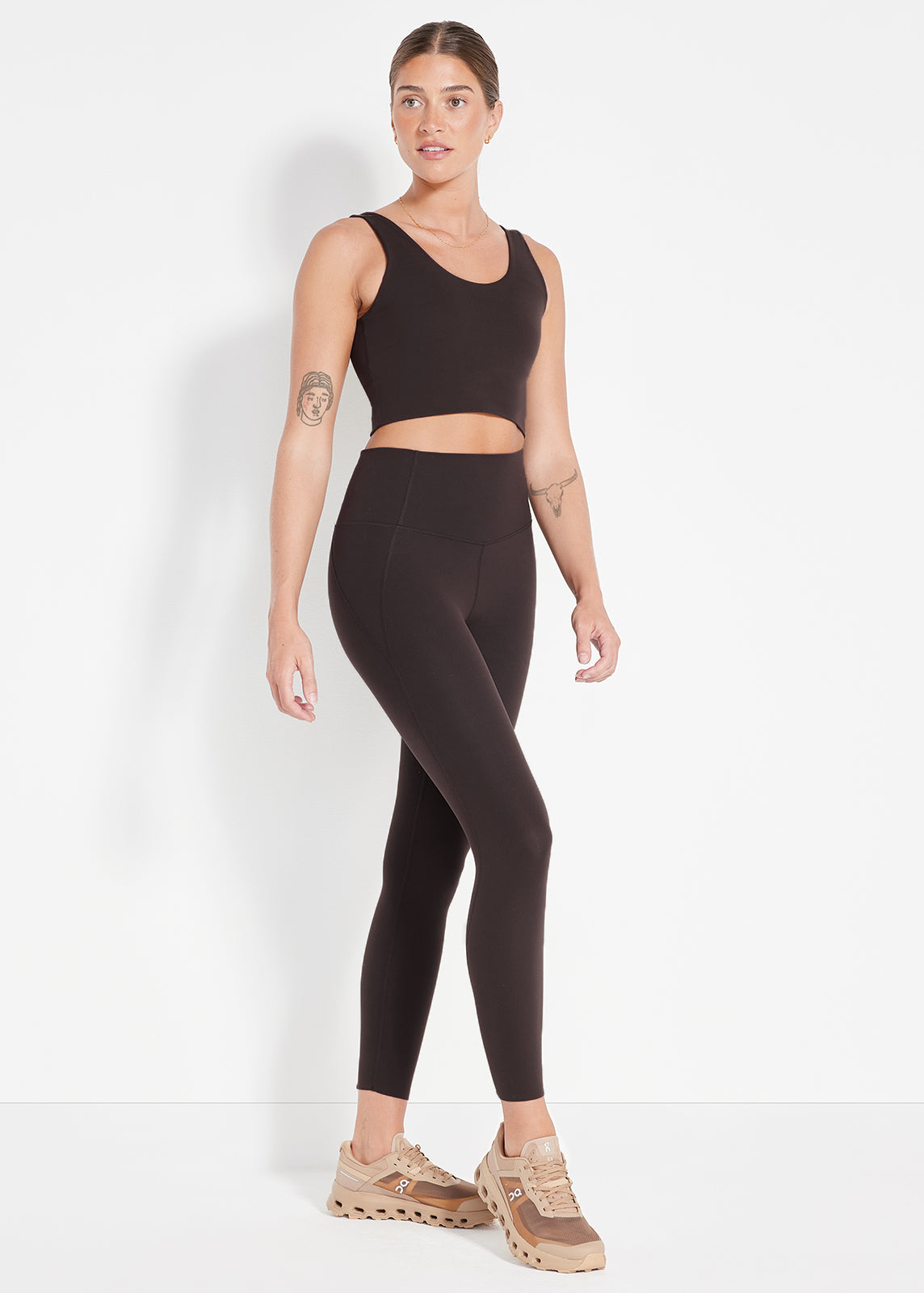 Model wearing chocolate brown leggings and matching scoop neck crop top