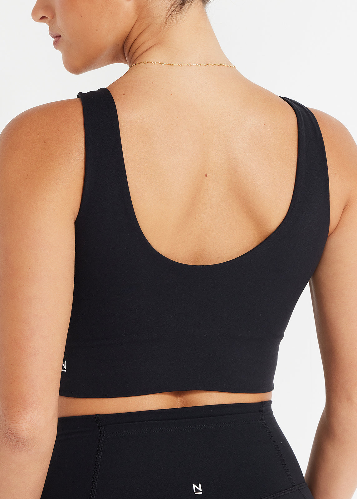 Back detail of scoop crop showing deep curved neckline and clean minimalist finish