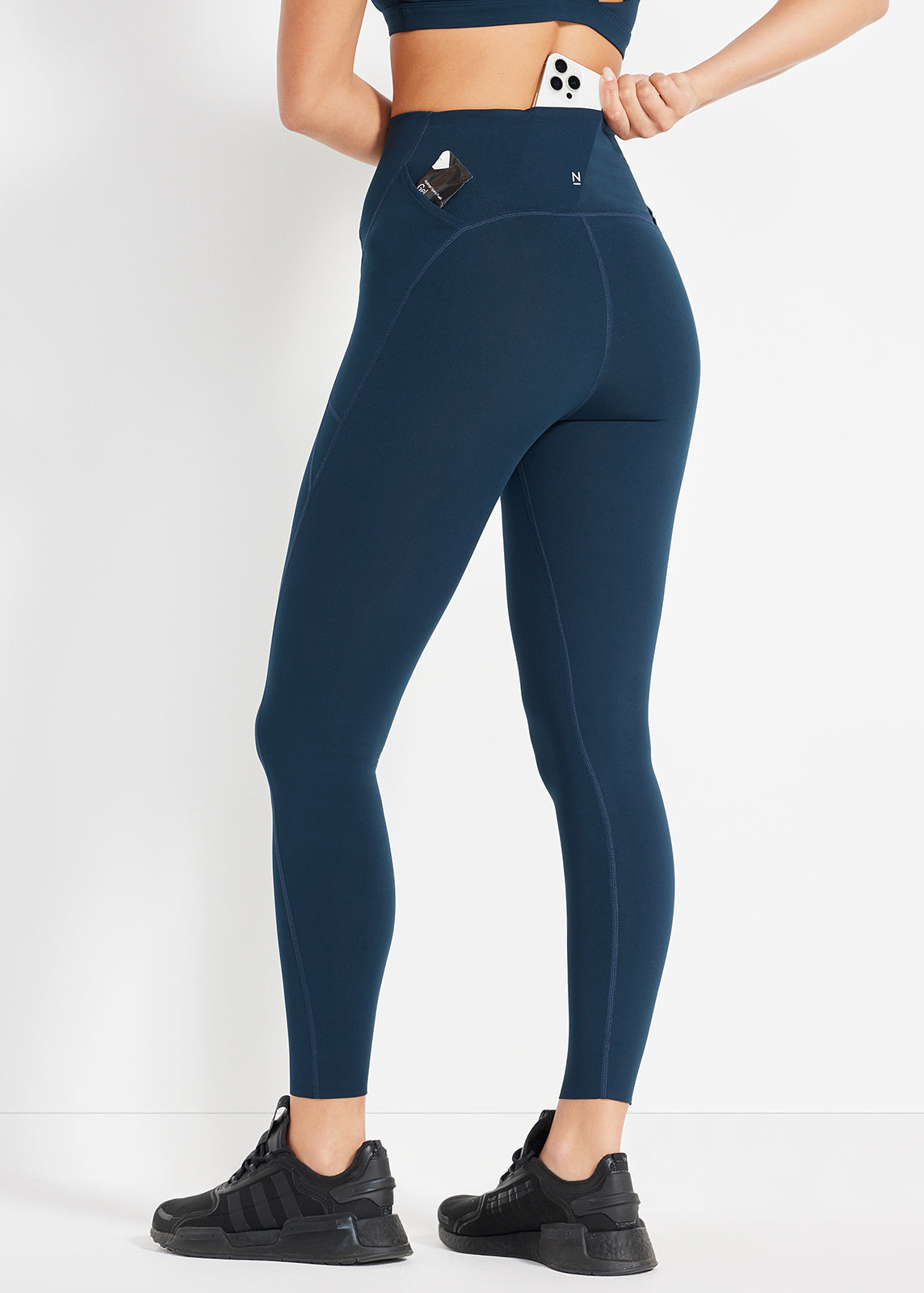 Back view of navy leggings showing pockets and sculpted fit