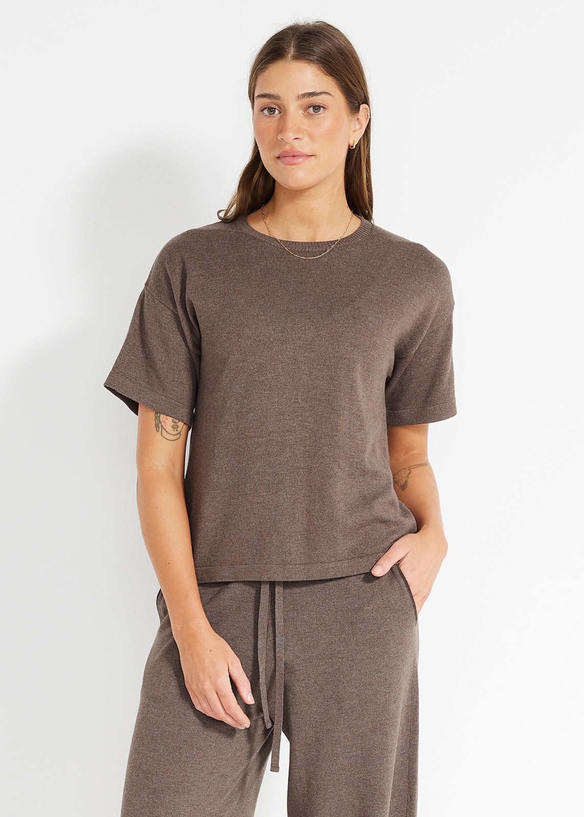 Model wearing brown short-sleeve knit top paired with matching wide-leg lounge pants
