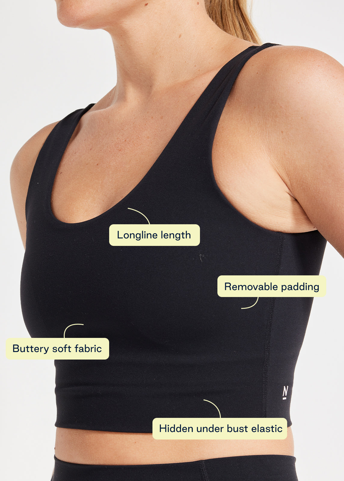 Close-up of black longline scoop bra highlighting buttery soft fabric, removable padding and hidden elastic