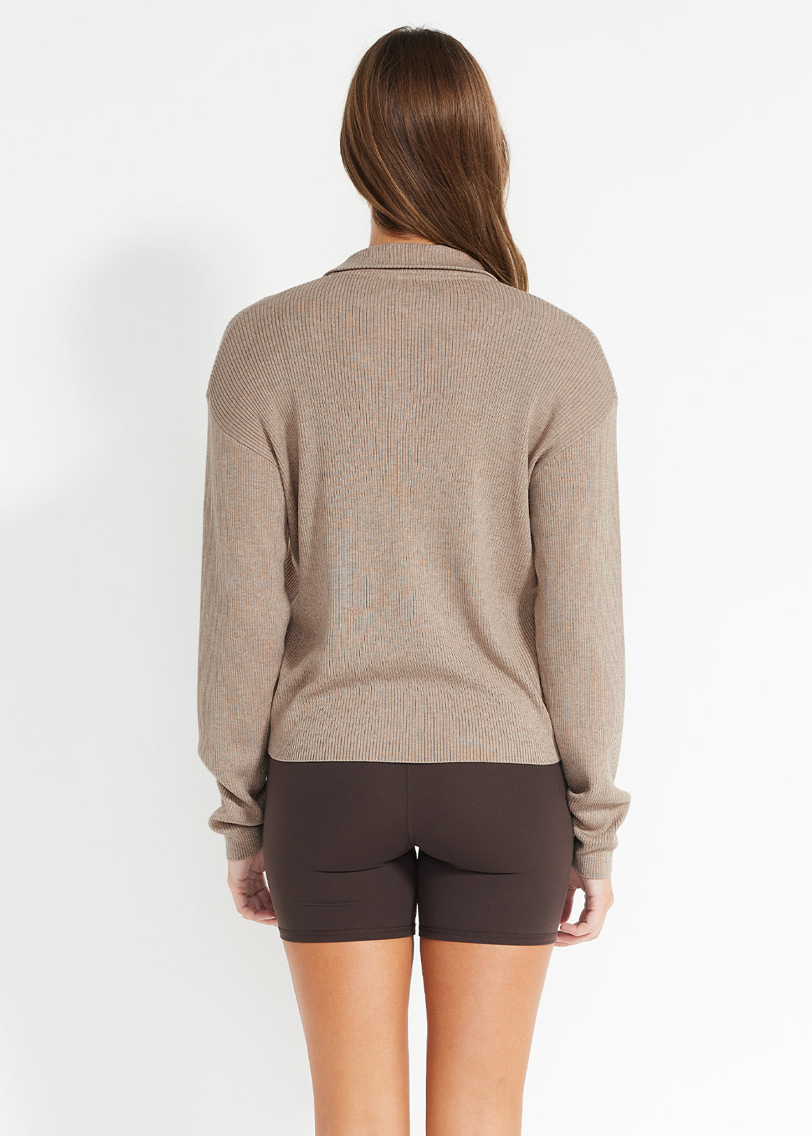 Back view of beige ribbed henley jumper paired with brown bike shorts