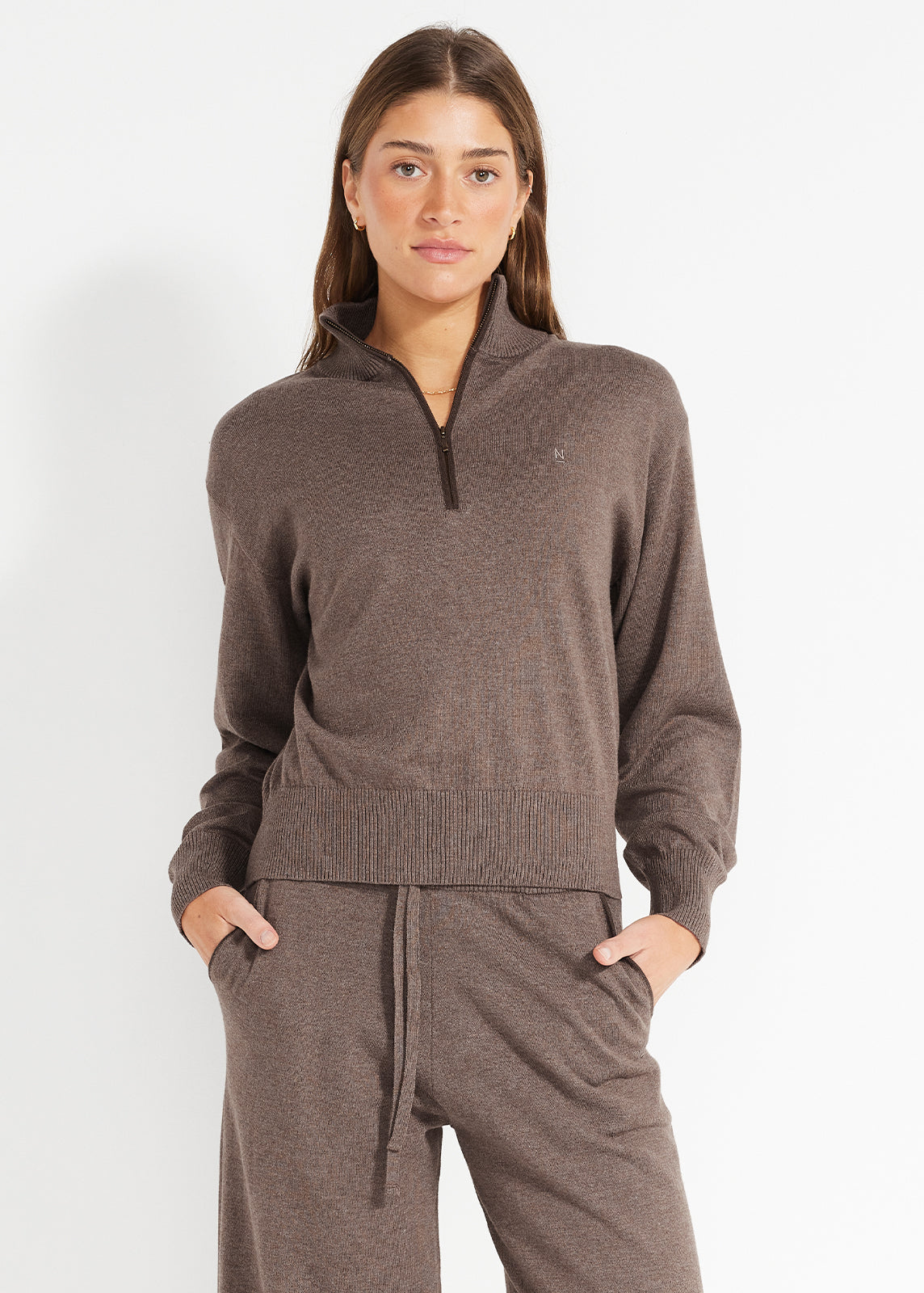 Model wearing brown half-zip knit jumper and matching drawstring lounge pants