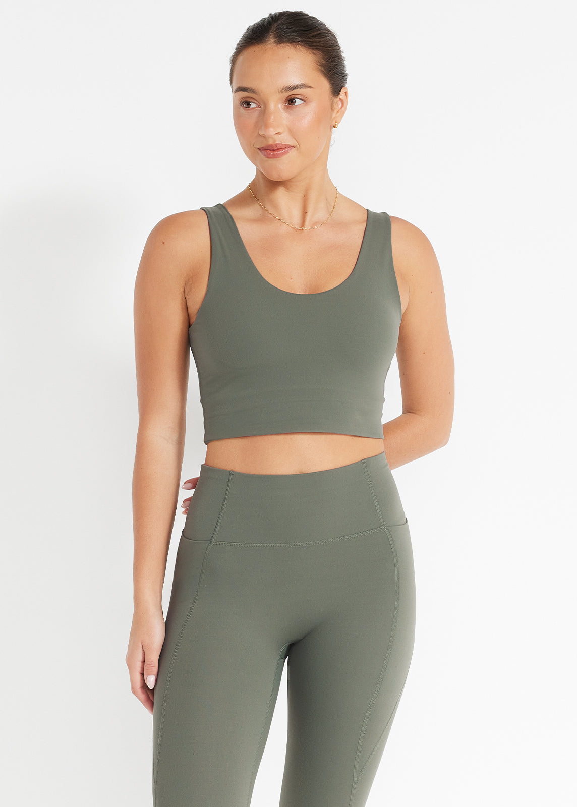 Close-up of black high-rise bike shorts made from recycled performance fabric, showing supportive fit and side seams